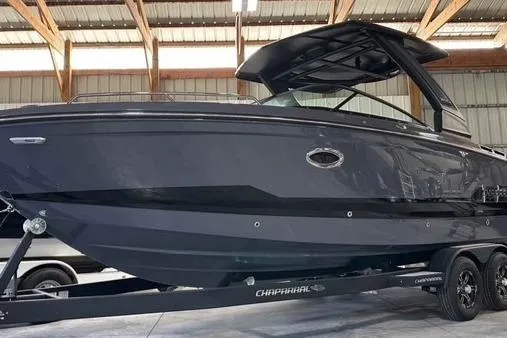 Slide: The Image of 2025 Chaparral 2870 SSX boat in a warehouse, sleek design, on a trailer. - 2