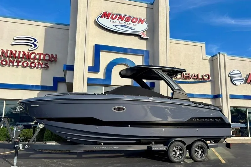 Slide: The Image of 2025 Chaparral 2870 SSX boat on trailer outside Munson Ski & Marine dealership. - 3