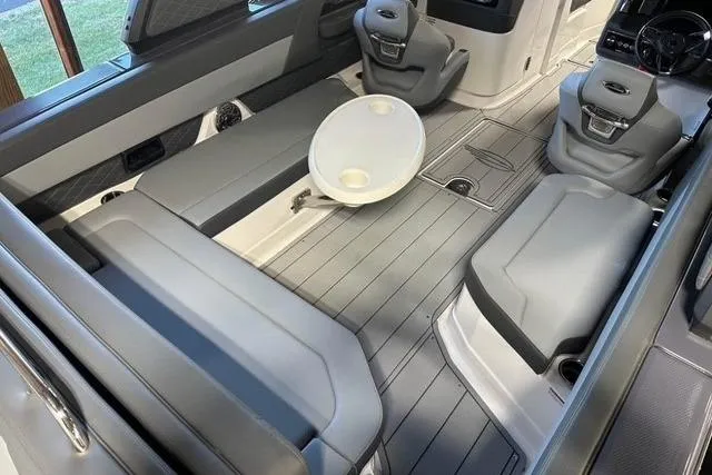 Slide: The Image of 2025 Chaparral 2870 SSX boat interior with gray seating and a round table. - 5