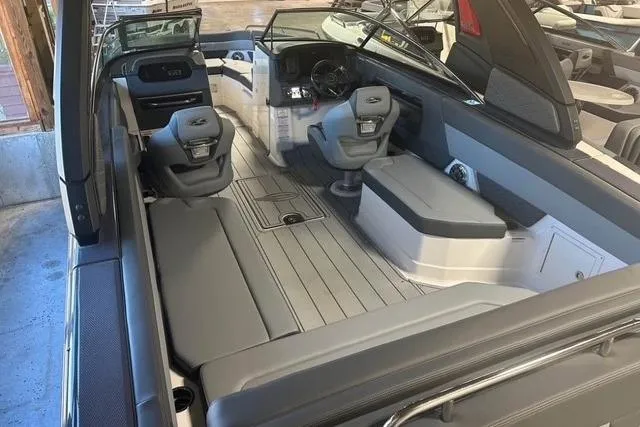 Slide: The Image of 2025 Chaparral 2870 SSX boat interior with sleek seating and modern dashboard. - 7