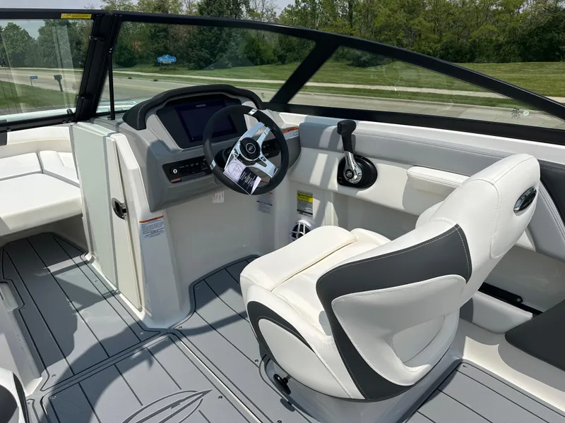 Slide: The Image of 2025 Chaparral 21 SSi boat interior with modern steering and seating. - 10