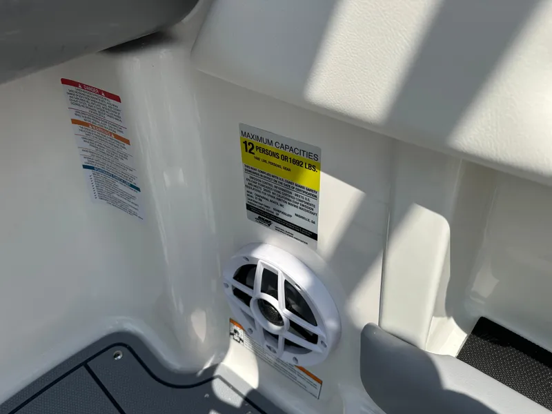 Slide: The Image of 2025 Chaparral 21 SSi boat interior showing capacity label and speaker. - 8