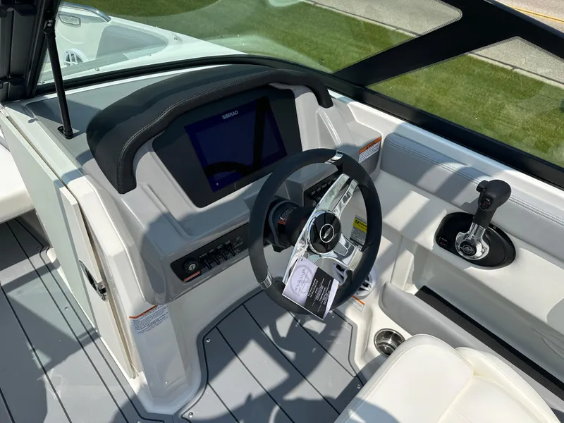 Slide: The Image of 2025 Chaparral 21 SSi boat dashboard with steering wheel and control panel. - 9