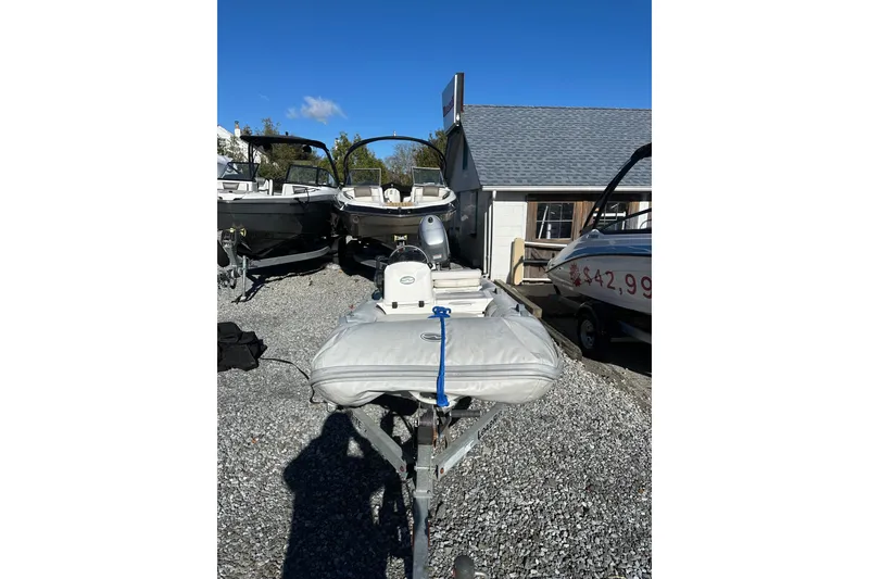 The Image of 2016 Walker Bay 325 ST inflatable boat on trailer, parked outdoors. - 1