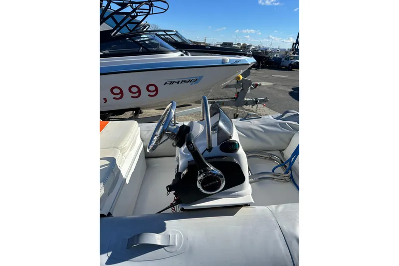 Slide: The Image of 2016 Walker Bay 325 ST boat interior with steering wheel and controls. - 11