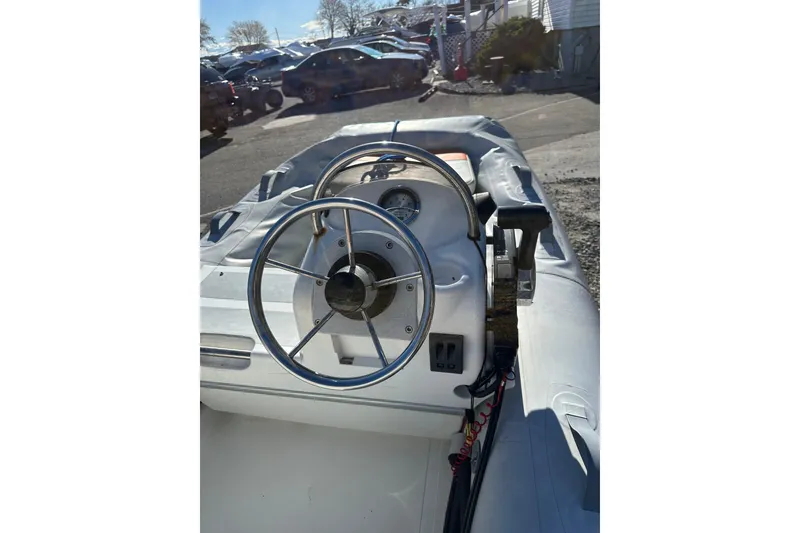 Slide: The Image of 2016 Walker Bay 325 ST boat interior with steering wheel and control panel. - 14