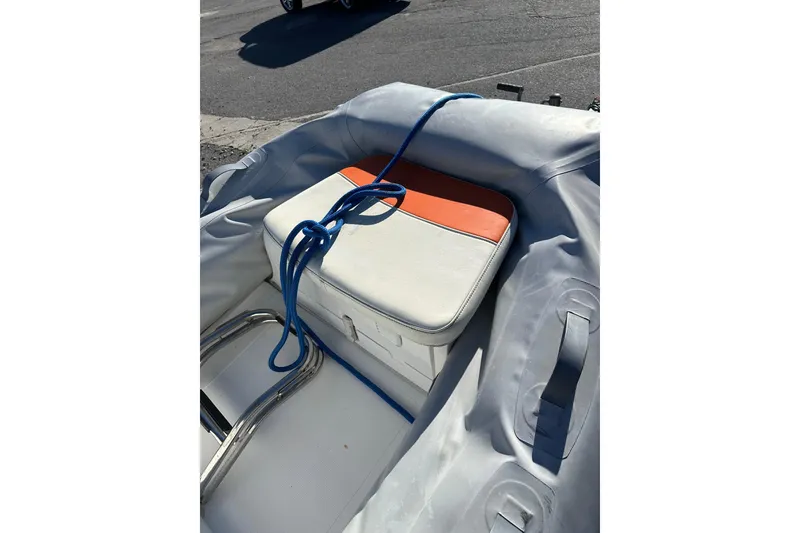 Slide: The Image of 2016 Walker Bay 325 ST inflatable boat with blue rope and cushioned seat. - 17