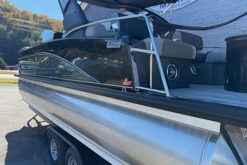 Slide: The Image of 2026 Avalon 2385 Catalina QLS Windshield pontoon boat, Platinum Edition, parked outdoors. - 5