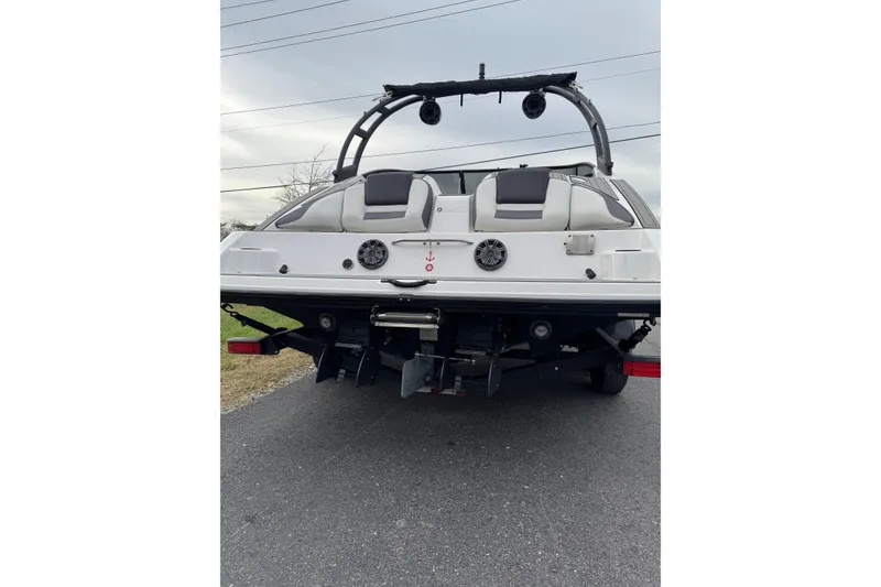 Slide: The Image of 2021 Yamaha Boats AR210 rear view on trailer, showcasing dual engines and wakeboard tower. - 3