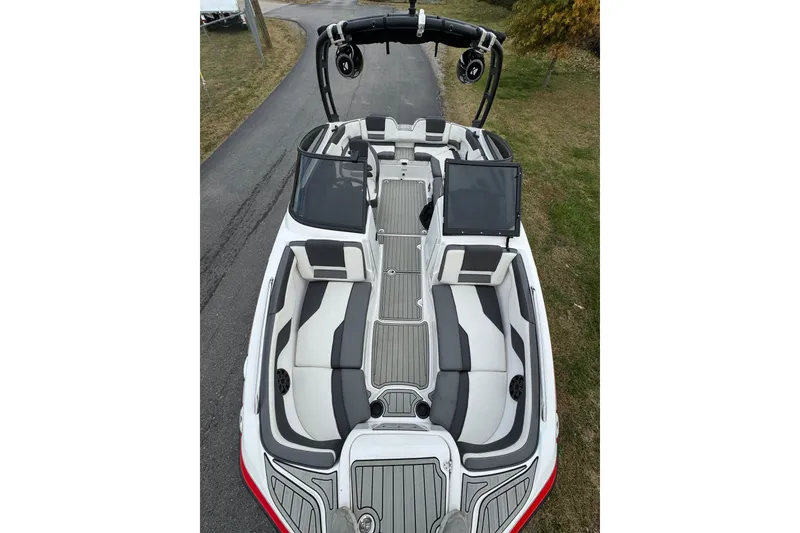 Slide: The Image of 2021 Yamaha AR210 boat with sleek seating and modern design on a road. - 4