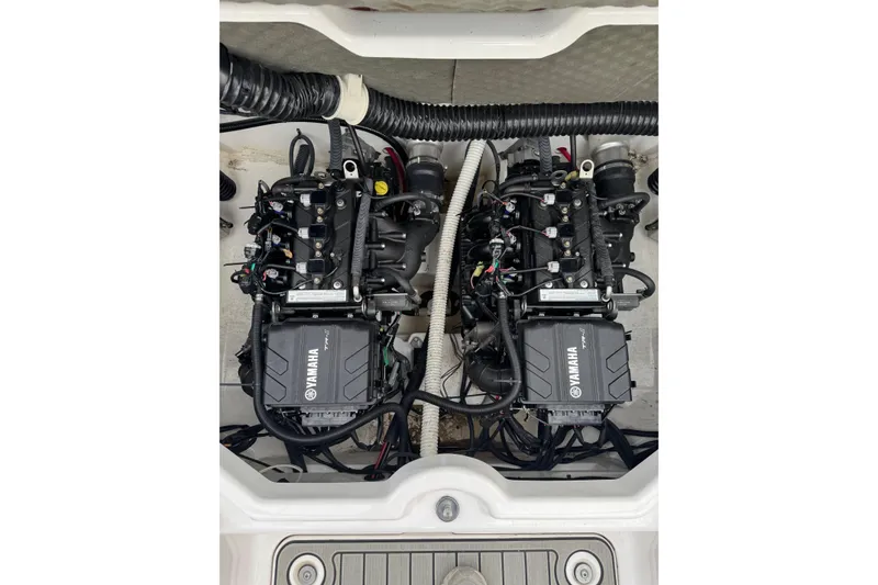 Slide: The Image of 2021 Yamaha AR210 boat engine compartment with dual engines, detailed view. - 8