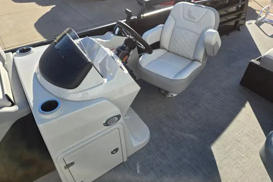 Slide: The Image of 2026 Lowe SS 230 DV boat interior with steering console and cushioned captain's chair. - 10