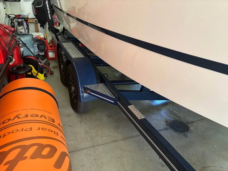Slide: The Image of Cobalt R3 Surf 2021 boat on trailer in garage. - 2