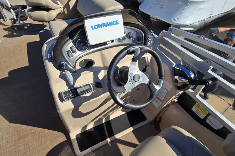 Slide: The Image of 2019 Sun Tracker Fishin' Barge 22 XP3 dashboard with steering wheel and Lowrance display. - 9