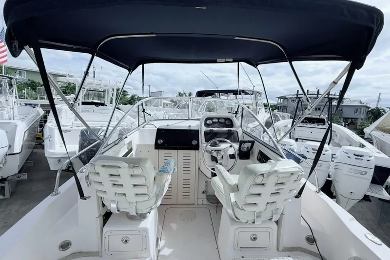 Slide: The Image of 2005 Grady-White Journey 258 boat interior with helm, seats, and canopy. - 10