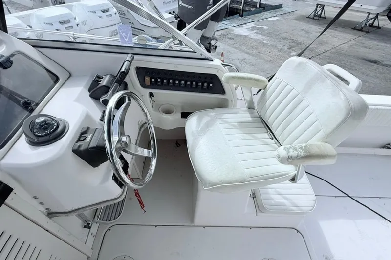 Slide: The Image of 2005 Grady-White Journey 258 boat helm with steering wheel and captain's chair. - 14