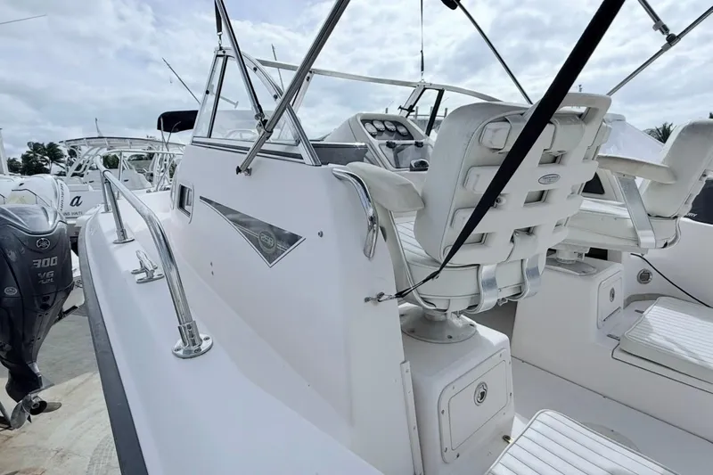 Slide: The Image of 2005 Grady-White Journey 258 boat interior with seating and controls, docked with Yamaha engine. - 15