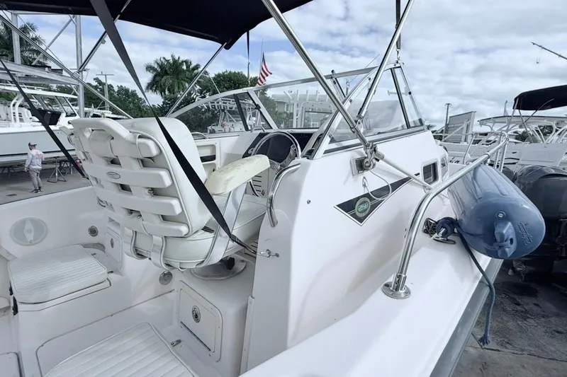 Slide: The Image of 2005 Grady-White Journey 258 boat interior with steering wheel and seating. - 16