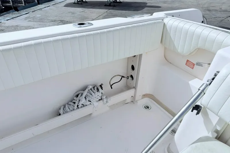Slide: The Image of 2005 Grady-White Journey 258 boat interior with white seating and coiled rope. - 17