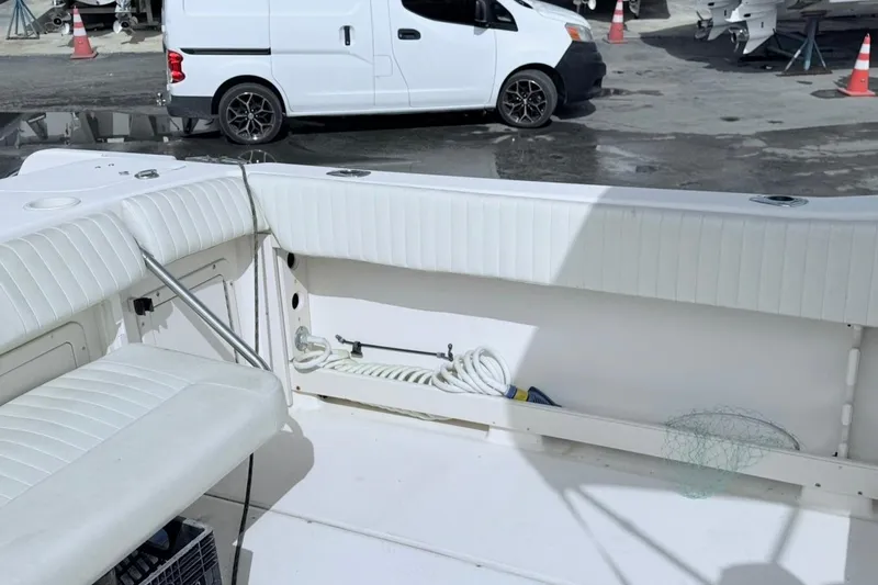 Slide: The Image of 2005 Grady-White Journey 258 boat interior with white seating and storage area. - 18