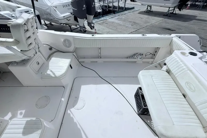 Slide: The Image of 2005 Grady-White Journey 258 boat interior with white seating and storage compartments. - 19