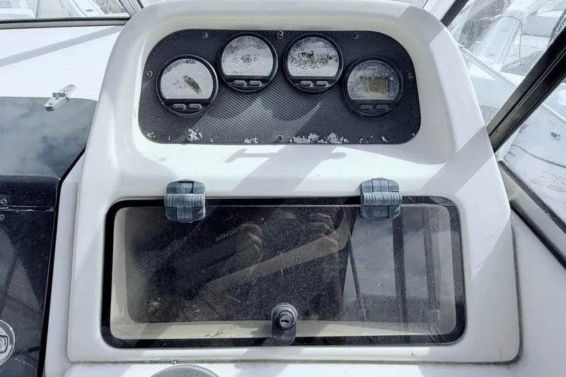 Slide: The Image of Dashboard of a 2005 Grady-White Journey 258 boat with gauges and storage compartment. - 22