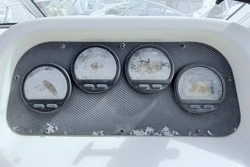 Slide: The Image of Dashboard of a 2005 Grady-White Journey 258 boat with four weathered gauges. - 23