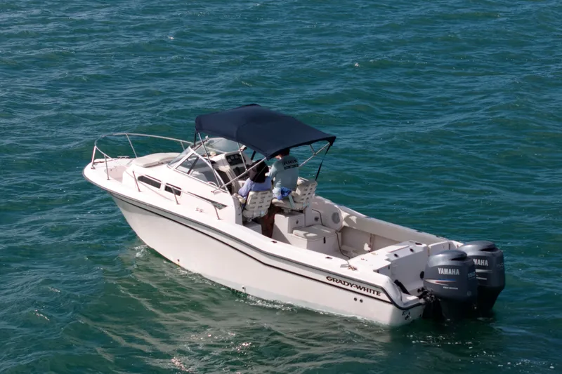 Slide: The Image of 2005 Grady-White Journey 258 boat cruising on clear blue water. - 3