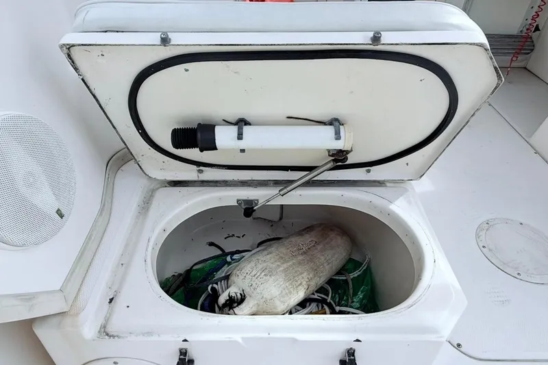 Slide: The Image of Open storage compartment on 2005 Grady-White Journey 258 boat with equipment inside. - 30