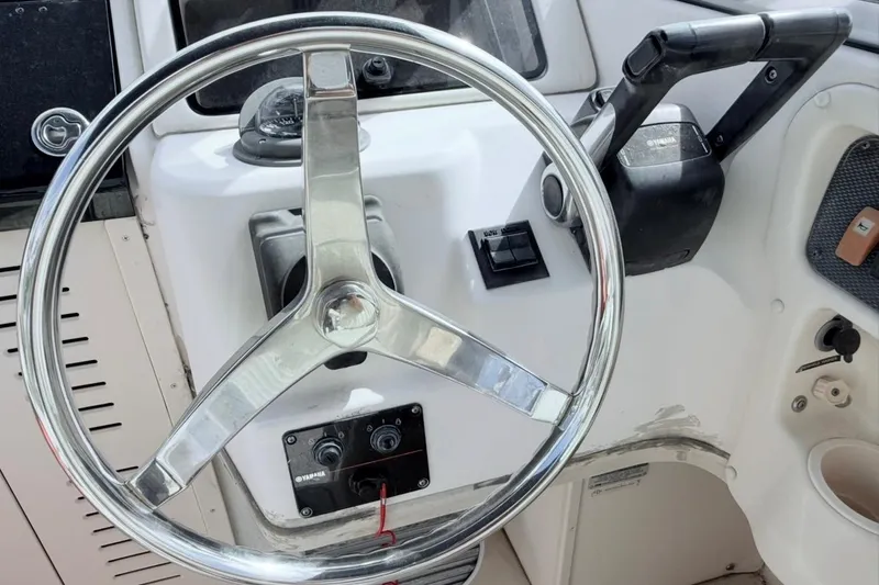 Slide: The Image of Steering wheel and controls of 2005 Grady-White Journey 258 boat. - 35