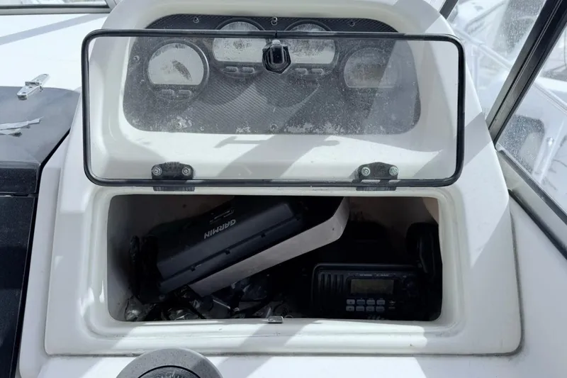Slide: The Image of Dashboard storage of 2005 Grady-White Journey 258 boat with Garmin device. - 37