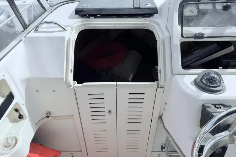 Slide: The Image of 2005 Grady-White Journey 258 boat interior with open cabin door and navigation instruments. - 38