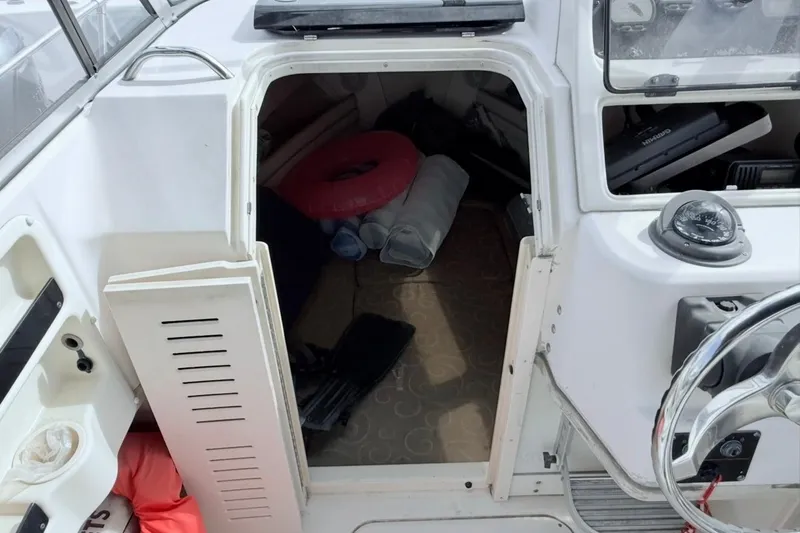 Slide: The Image of 2005 Grady-White Journey 258 boat cabin interior with life jackets and equipment. - 39