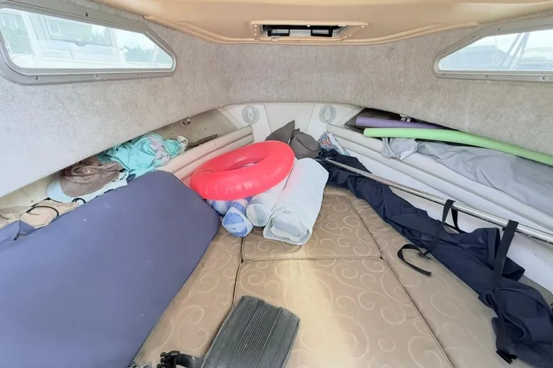 Slide: The Image of 2005 Grady-White Journey 258 cabin interior with cushions and boating accessories. - 42