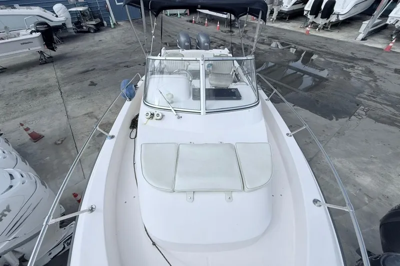 Slide: The Image of 2005 Grady-White Journey 258 boat docked, featuring spacious deck and dual engines. - 49