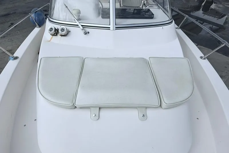 Slide: The Image of 2005 Grady-White Journey 258 boat deck with cushioned seating and windshield. - 50