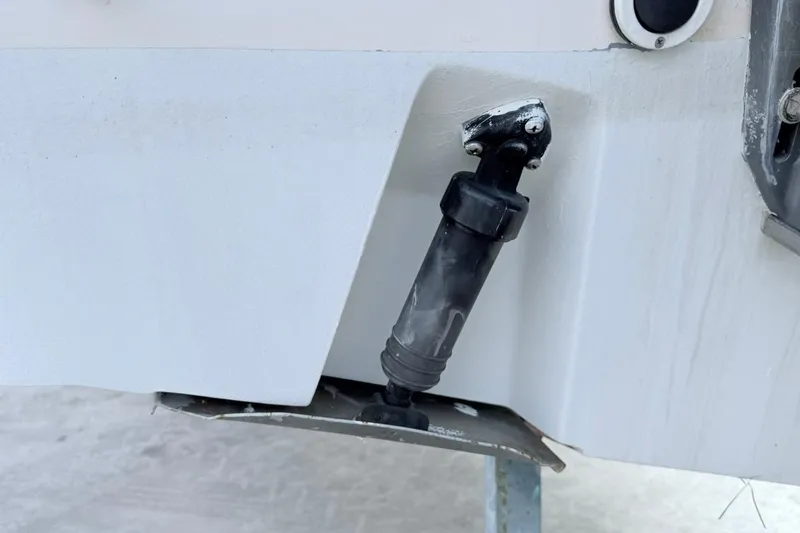 Slide: The Image of 2005 Grady-White Journey 258 boat detail showing hydraulic component on hull. - 59