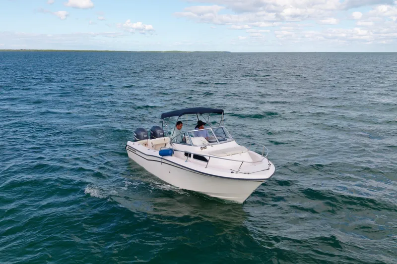 Slide: The Image of 2005 Grady-White Journey 258 boat cruising on open water under a clear sky. - 6