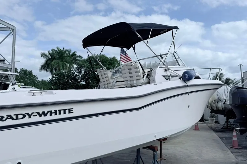 Slide: The Image of 2005 Grady-White Journey 258 boat with canopy, docked outdoors. - 63