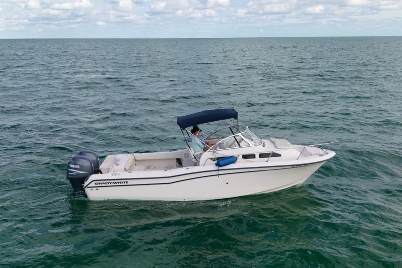 Slide: The Image of 2005 Grady-White Journey 258 boat on open sea with Yamaha engine. - 7