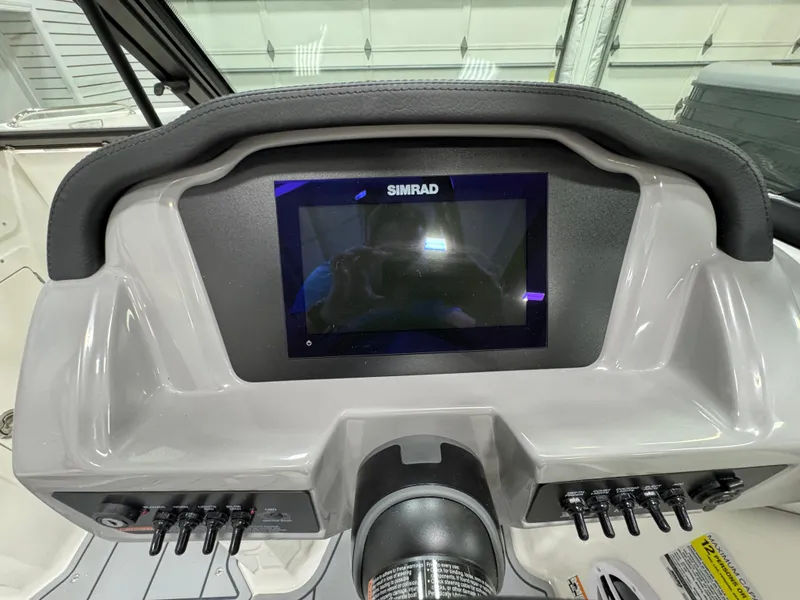 Slide: The Image of Dashboard of 2025 Chaparral 21 SSi boat featuring a Simrad display. - 15