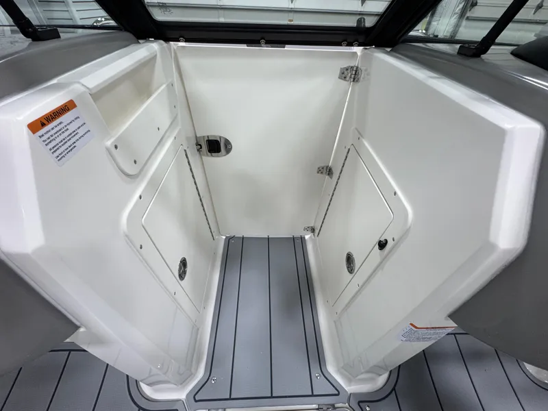 Slide: The Image of Interior view of 2025 Chaparral 21 SSi boat, featuring storage compartments and sleek design. - 19