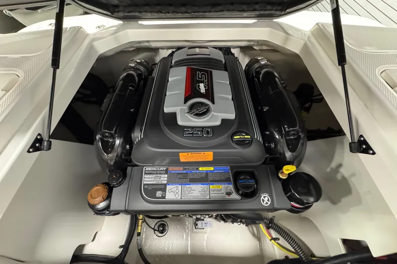 Slide: The Image of Engine compartment of a 2025 Chaparral 21 SSi boat, featuring a powerful motor. - 23