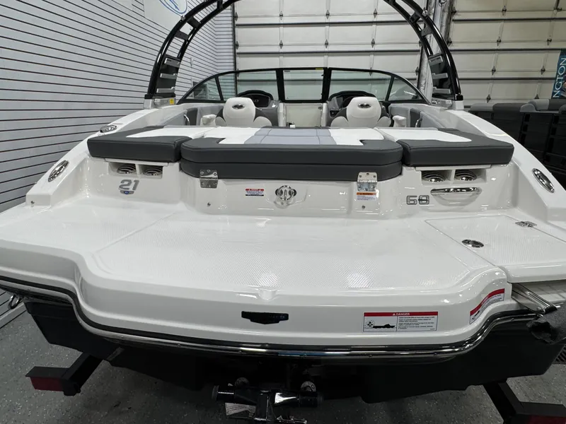 Slide: The Image of 2025 Chaparral 21 SSi boat, rear view, showcasing sleek design and spacious seating. - 7