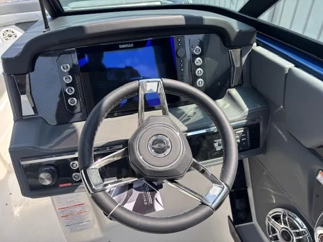Slide: The Image of 2026 Chaparral SSX 6 boat dashboard with steering wheel and digital display. - 11
