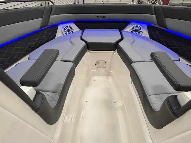 Slide: The Image of 2026 Chaparral SSX 6 boat interior with blue LED lighting and cushioned seating. - 14