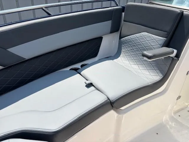 Slide: The Image of 2026 Chaparral SSX 6 boat interior with gray and black cushioned seating. - 21