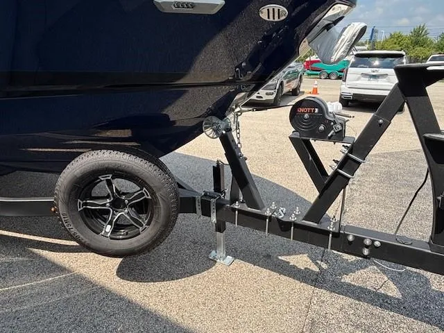 Slide: The Image of 2026 Chaparral SSX 6 boat on trailer, featuring black wheel and hitch mechanism. - 38