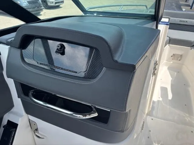 Slide: The Image of 2026 Chaparral SSX 6 boat interior with sleek dashboard and storage compartment. - 39