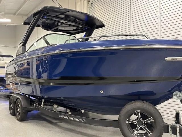 Slide: The Image of 2026 Chaparral SSX 6 boat in showroom, sleek blue design on trailer. - 42